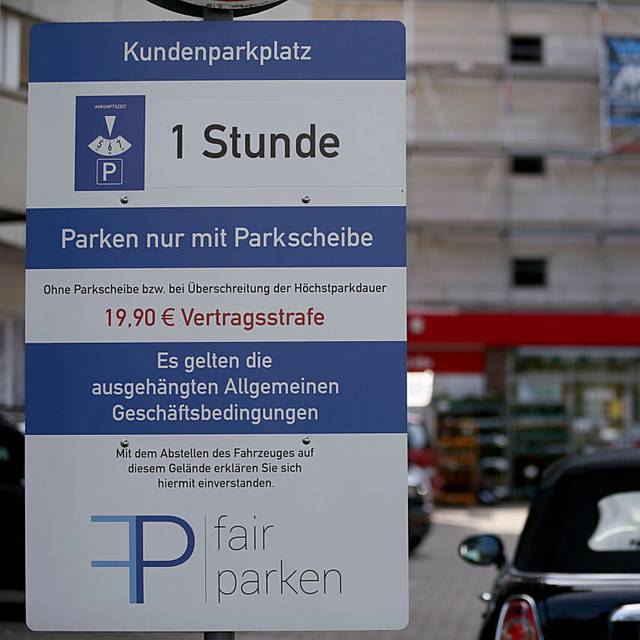 Ein Hinweisschild auf einem Parkplatz zwecks Gebühren ist zu erkennen.