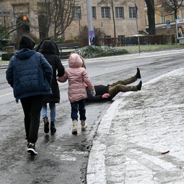 Ein Mann stürzt bei Eisglätte vom Gehweg auf die Straße